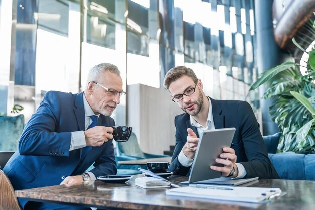 two-business-professionals-discussing-marketing-strategy-with-tablet-and-coffee-in-modern-office-setting