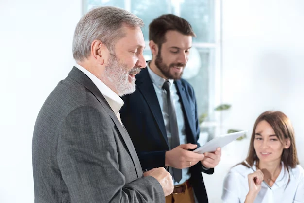 team-discussing-ppc-presentation-in-office-with-tablet-and-notepad
