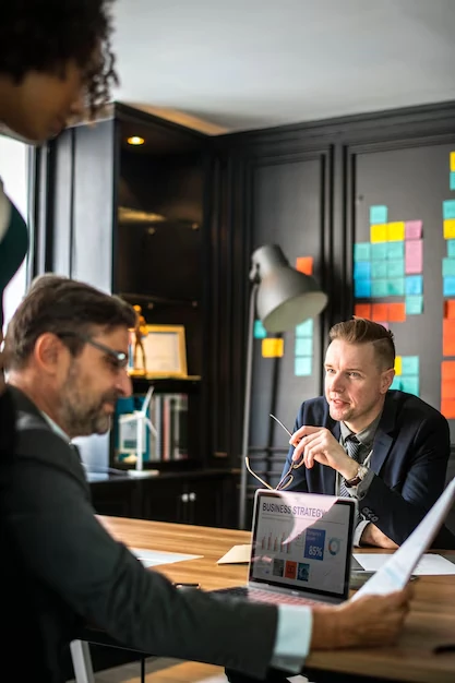 Marketing-strategy-meeting-in-modern-office-with-colleagues-discussing-financial-performance-and-planning-for-growth