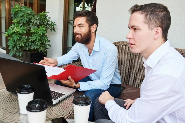 professionals-discussing-marketing-plan-outdoor-setting-with-laptop-and-coffee